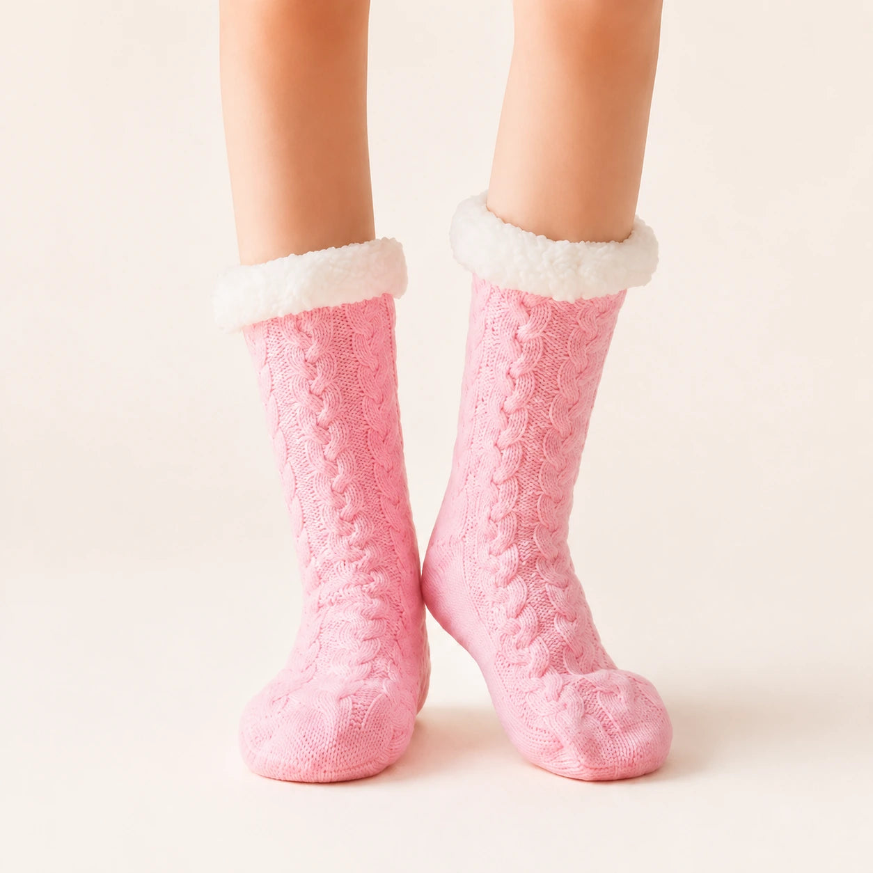 Pink sherpa-lined slipper socks worn on feet