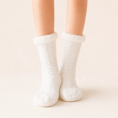 White sherpa-lined slipper socks worn on feet