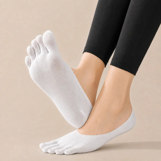 White BareToe five-toe invisible socks worn on both feet against a neutral studio background