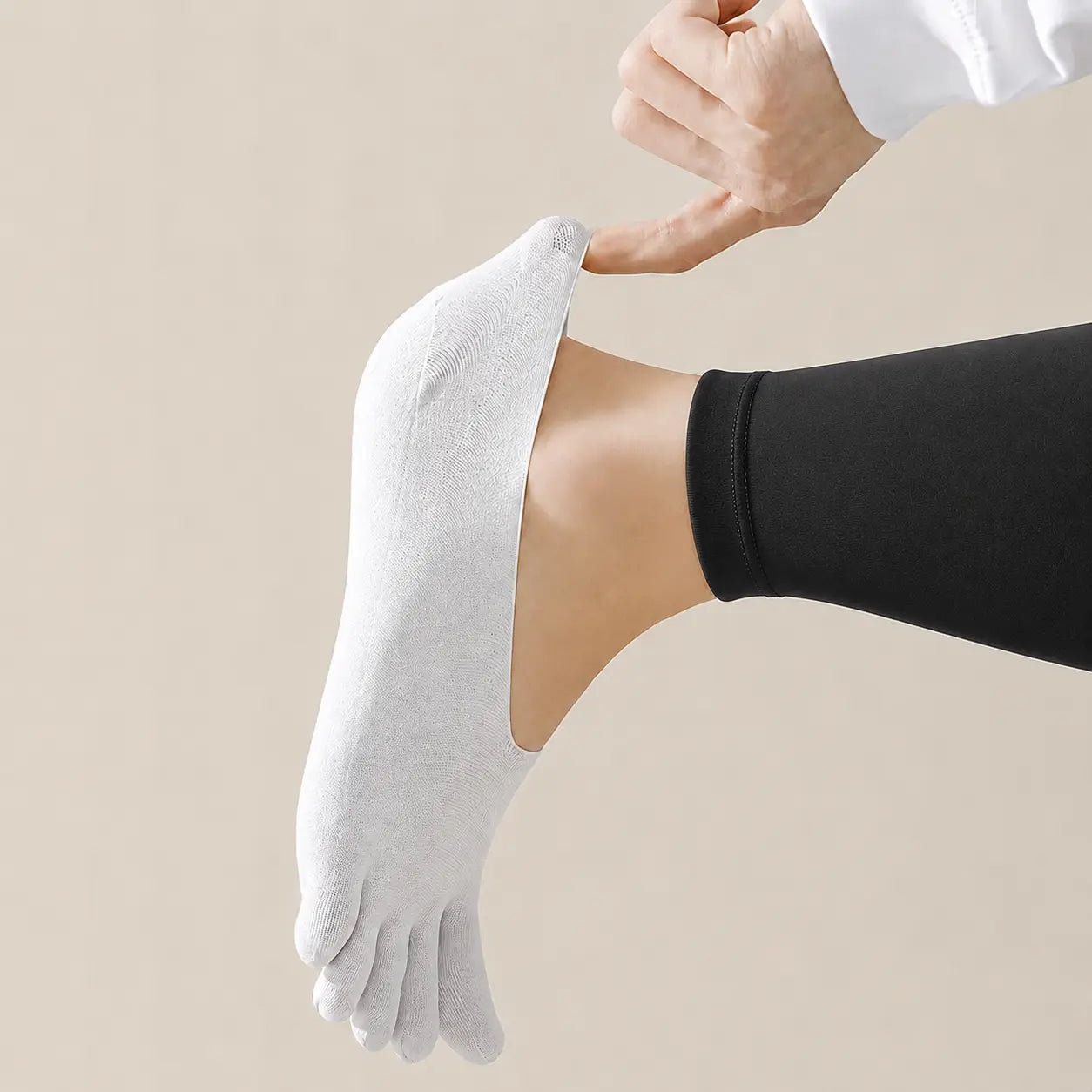 White BareToe invisible sock stretched at the toe to demonstrate its flexible lightweight fabric